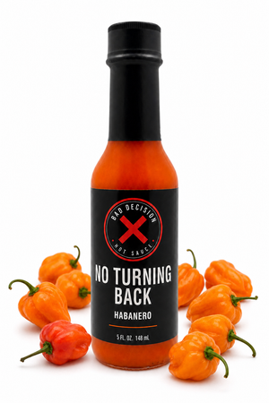 No Turning Back habanero hot sauce bottle surrounded by fresh habanero peppers