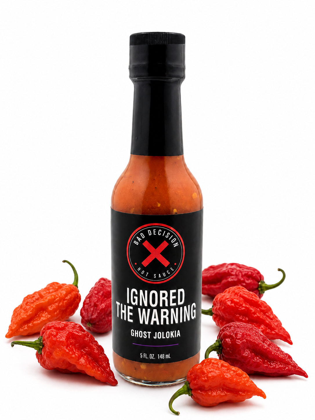 Ignored The Warning ghost jolokia hot sauce bottle surrounded by red ghost peppers