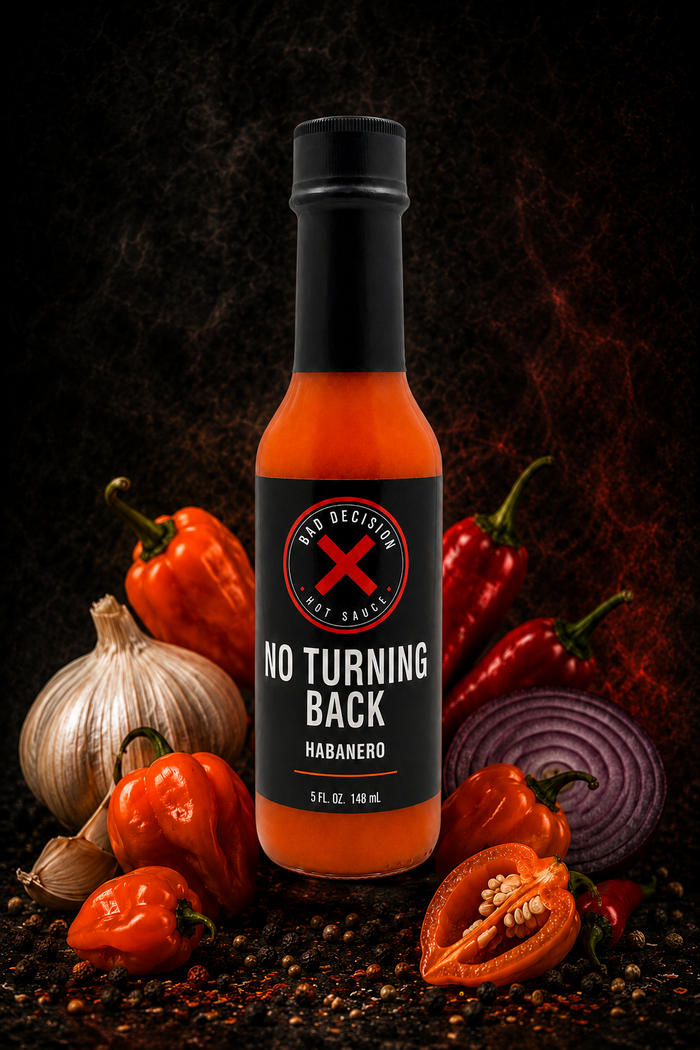 No Turning Back habanero hot sauce bottle with fresh habaneros and ingredients on a dark background